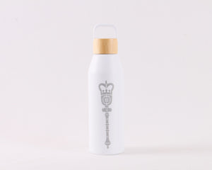 White water bottle with a brown bamboo screw top lid, with a gray laser engraved Alberta Mace on the front.