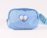 Light blue fanny pack featuring a pixelated heart design with the Alberta Legislature building at the center, displayed with adjustable strap and zippered main compartment