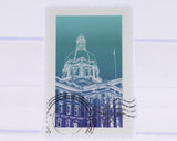 Stylized illustration of a building with a dome on a blue background, resembling a postage stamp.