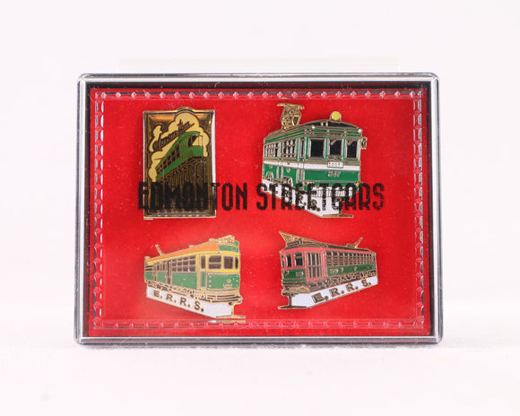 A red velvet box with 4 different enamel pins. All 4 pins feature a High-level Bridge streetcar