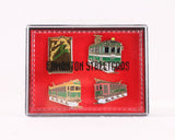 A red velvet box with 4 different enamel pins. All 4 pins feature a High-level Bridge streetcar