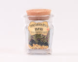 A glass jar with a cork lid containing a mixture of various beans. The label reads: "VEGETARIAN BEAN SOUP MIX / Mélange à Soupe de Haricots Végétariens / HANDMADE IN ALBERTA."