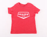 A red youth t-shirt with 'PRAIRIE MADE' printed in white text on the front.
